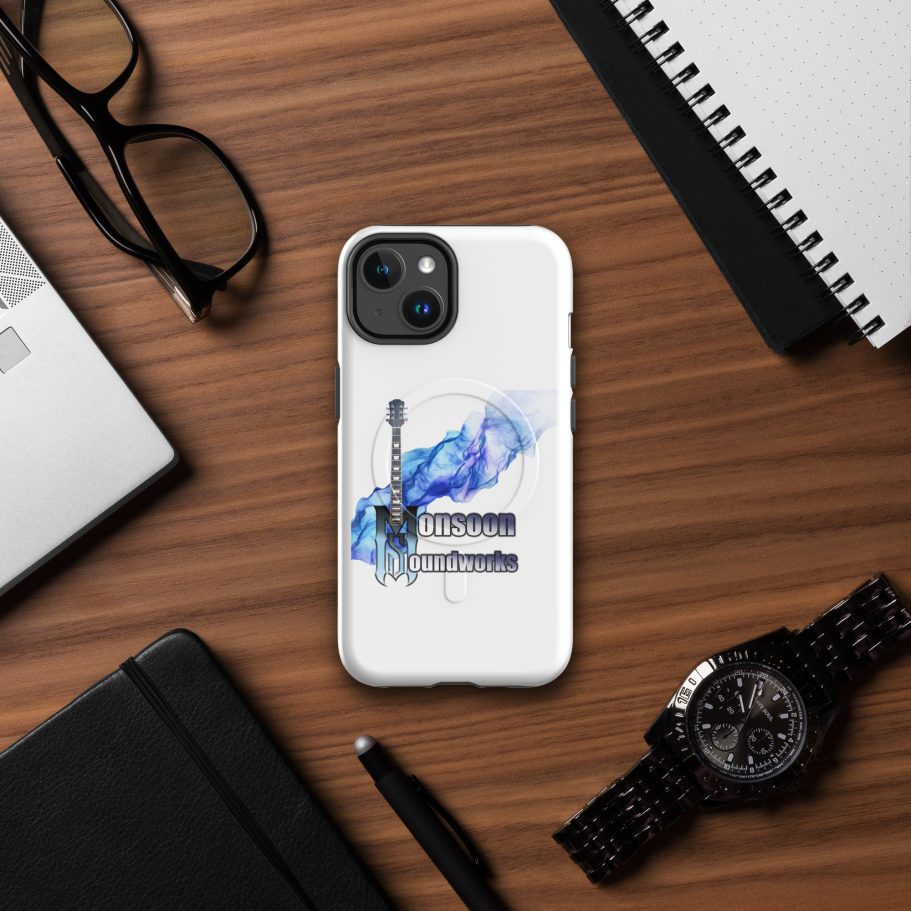 A smartphone with a stylised design on a wooden desk beside glasses and a notebook.